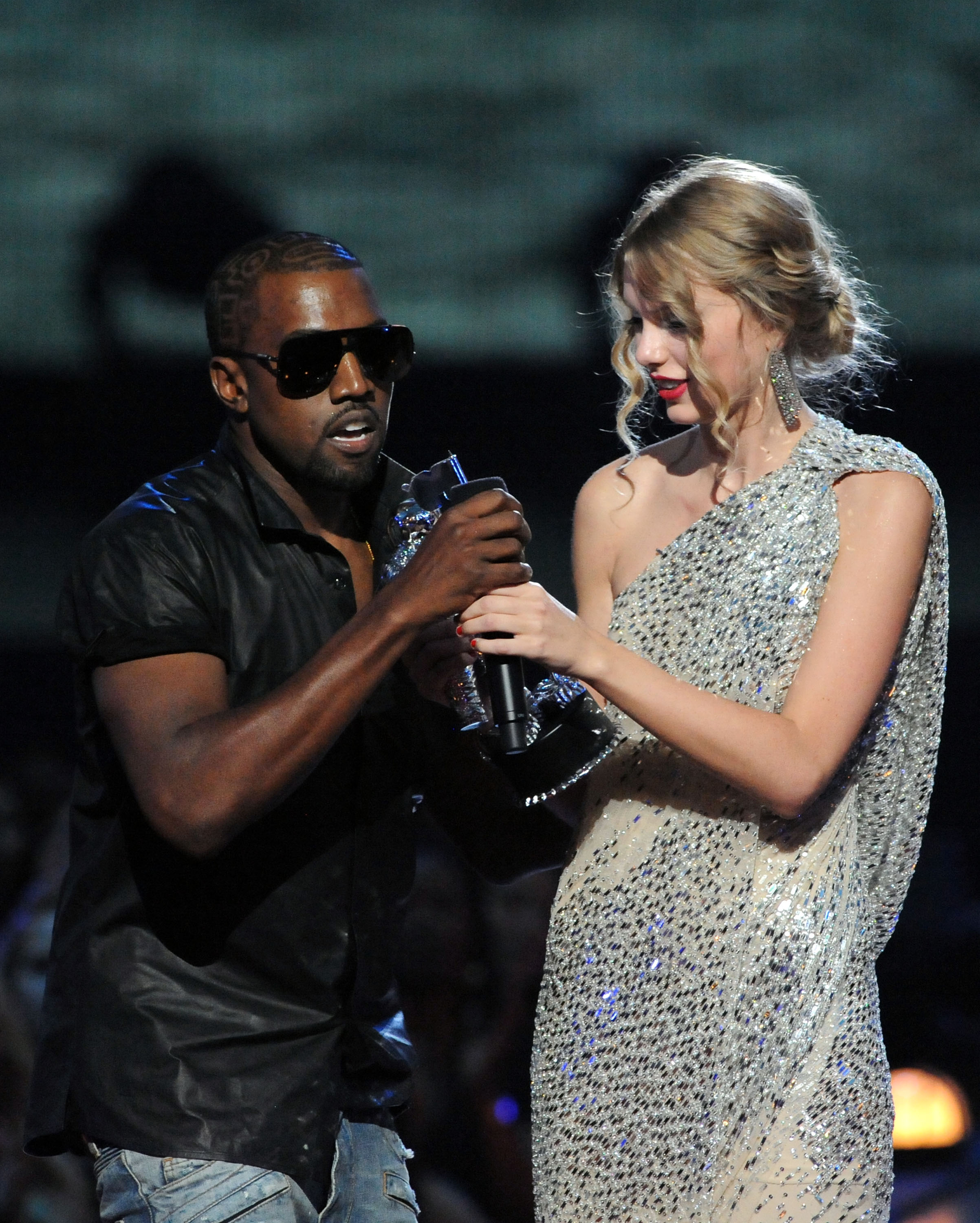 Kanye West jumps onstage as Taylor Swift accepts her award during the 2009 MTV Video Music Awards.