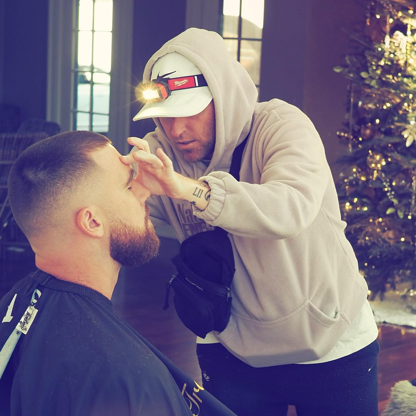 Travis Kelce getting his hair cut.