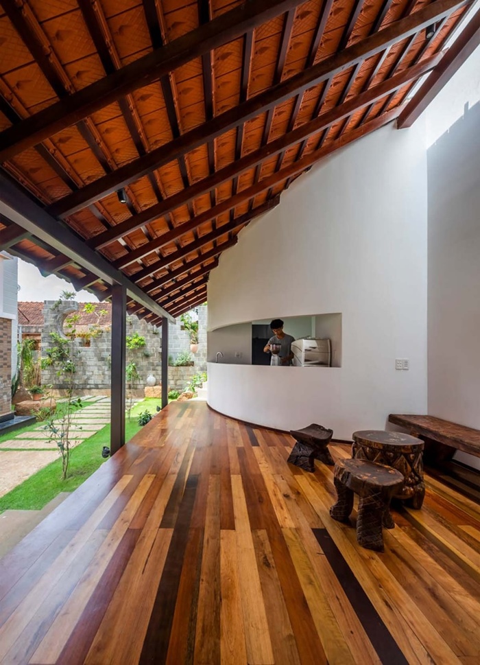 The house has a wide veranda and a raised platform.