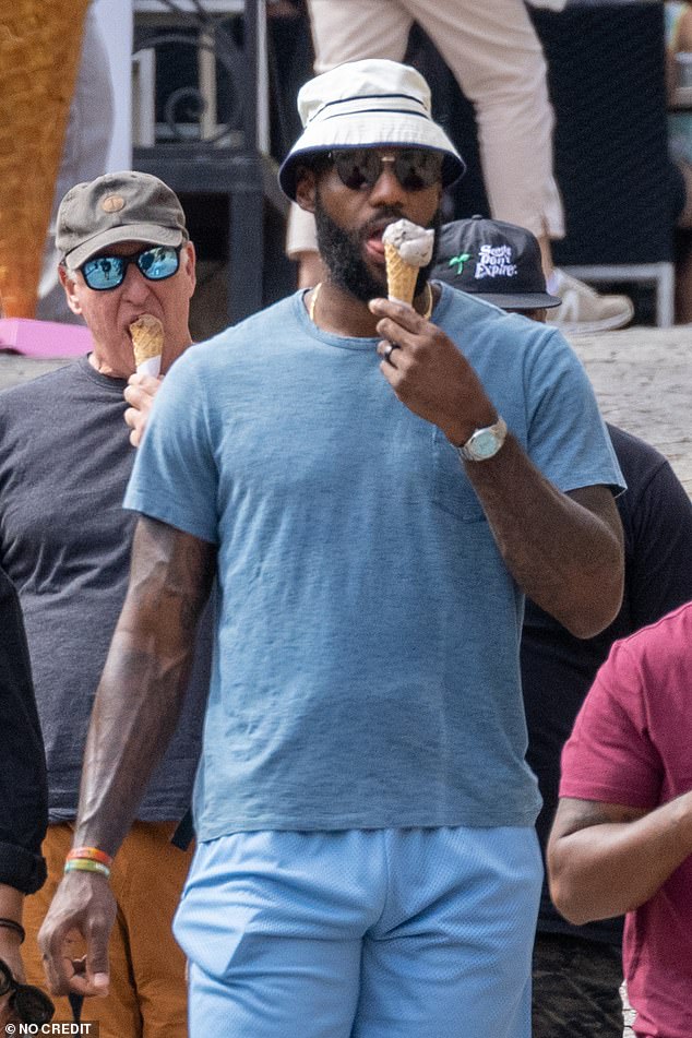 Details: He accessorised with a statement watch, a beige bucket hat and trendy sunglasses