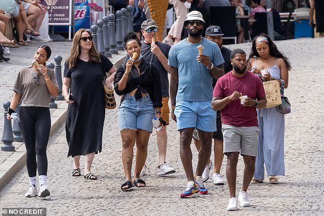 At ease: Savannah cut an effortlessly chic figure in a black and denim ensemble (pictured), and like LeBron, wandered through the picturesque locale with an ice cream in hand