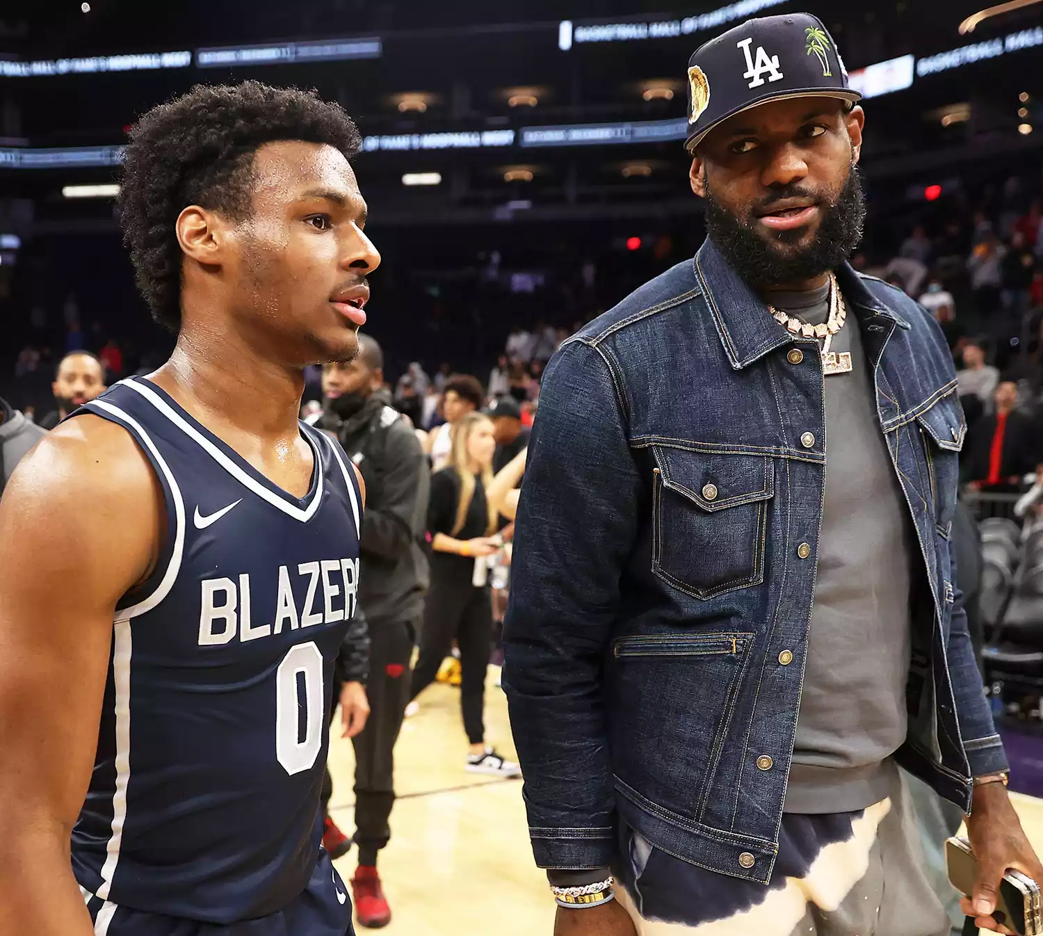 Bronny James #0 of the Sierra Canyon Trailblazers and father LeBron James of the Los Angeles Lakers walk off the court following the Hoophall West tournament at Footprint Center on December 11, 2021 in Phoenix, Arizona.