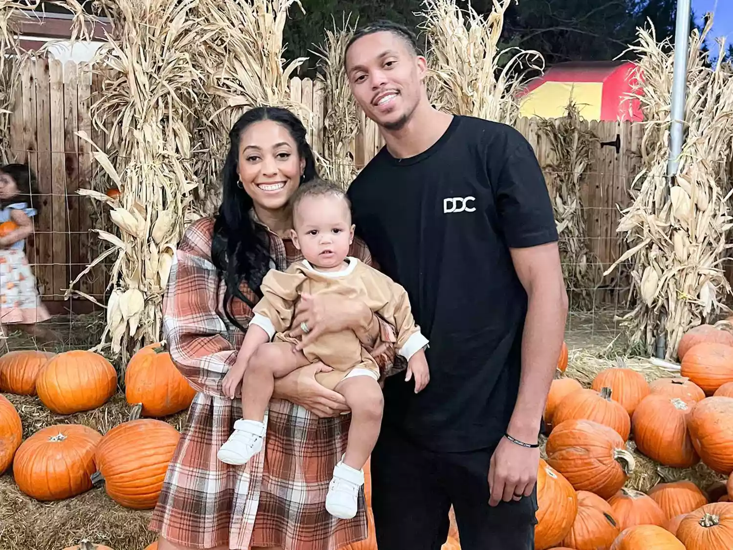 Sydel Curry and Damion Lee with their son at a pumpkin patch